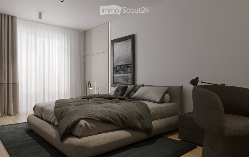 Modern bedroom with a large bed, grey bedding, a sofa, a table lamp, and a picture frame on the wall. The room features large windows with curtains and a sleek, contemporary design.
