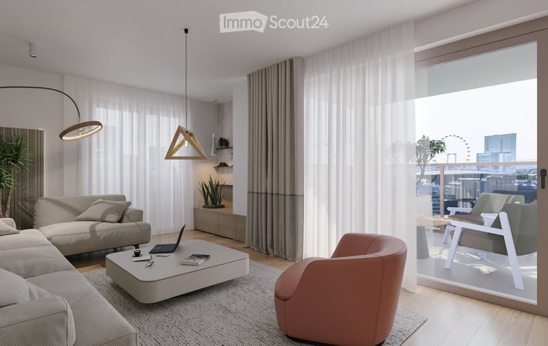Modern living room with a grey sofa, coffee table, laptop, and a pink armchair. Large windows with sheer curtains and a view of the city.