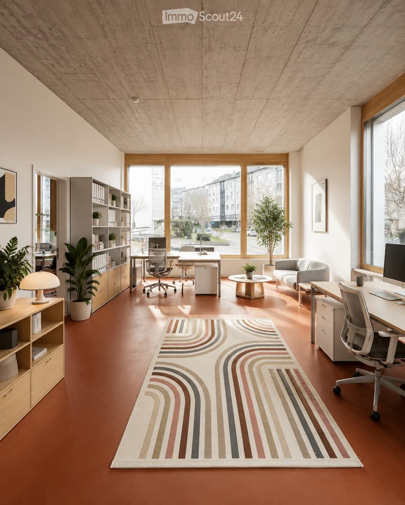 Modern office space with large windows, wooden flooring, and contemporary furniture including a sofa, desks, chairs, and a bookshelf.