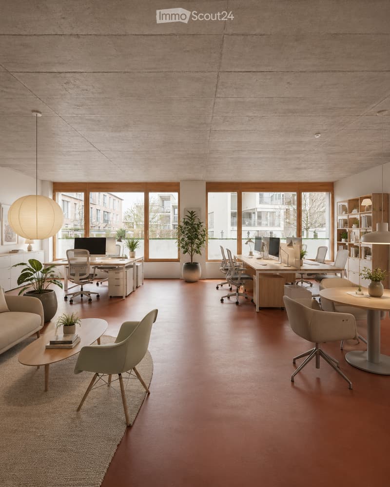 Modern office space with a lounge area and workstations. Features a red floor, large windows, a sofa, coffee table, office desks, chairs, computers, lamps, and plants.