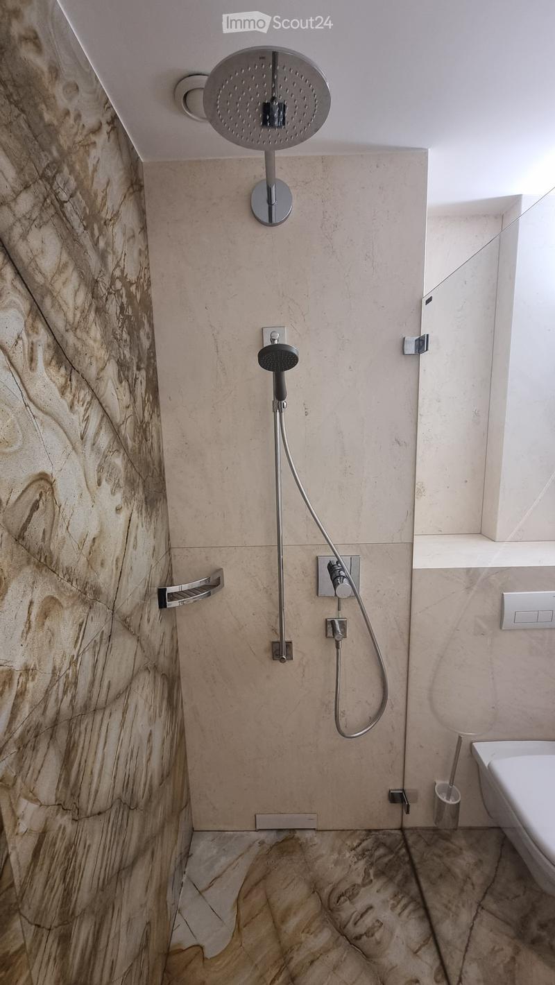 shower area with shower head, shower arm, and shower hose