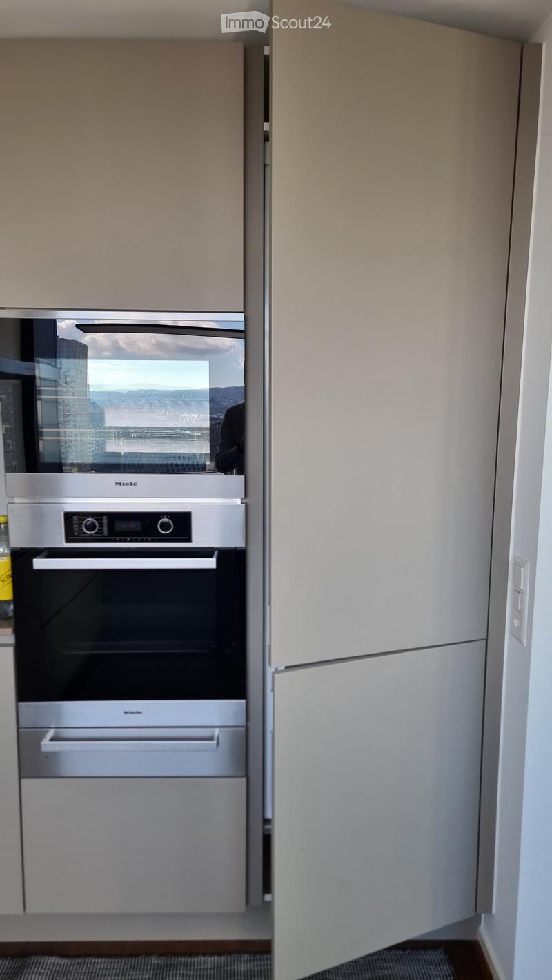 modern kitchen with stainless steel appliances, white cabinets, dishwasher