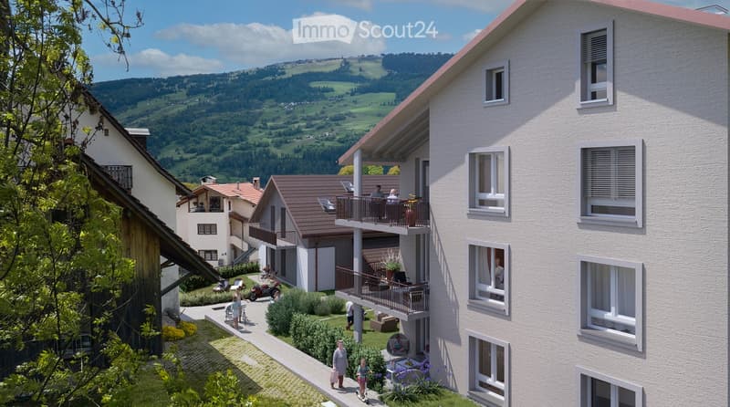 A multi-story residential building with balconies overlooking a scenic valley and hills, surrounded by greenery and pathways.