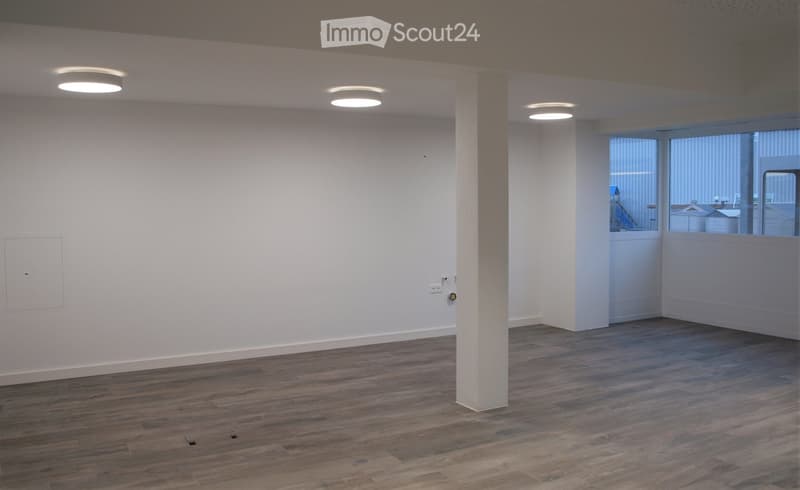 Empty room with wooden flooring, white walls, and recessed lighting. No furniture or equipment present.