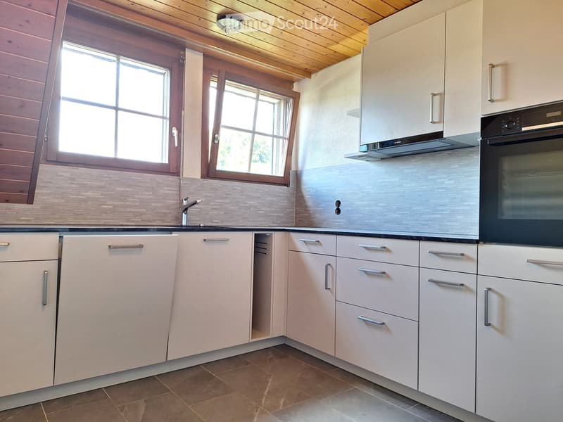 white cabinets, tiled flooring, two large windows with wooden frames, sink with faucet, tiled backsplash