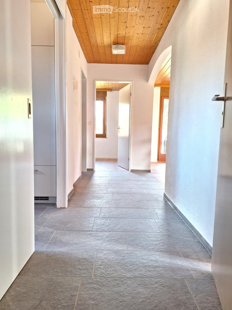 empty hallway, white walls, wooden ceiling, tiled floor