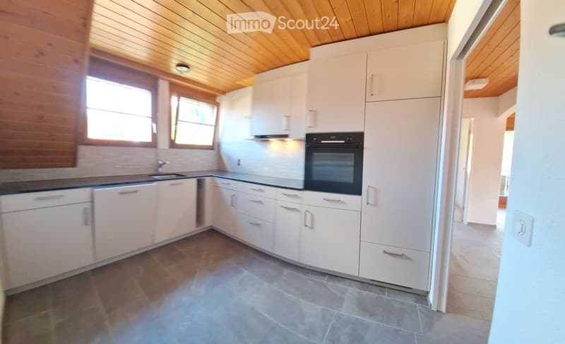 white kitchen with gas oven, sink, refrigerator, drawers, wooden ceiling