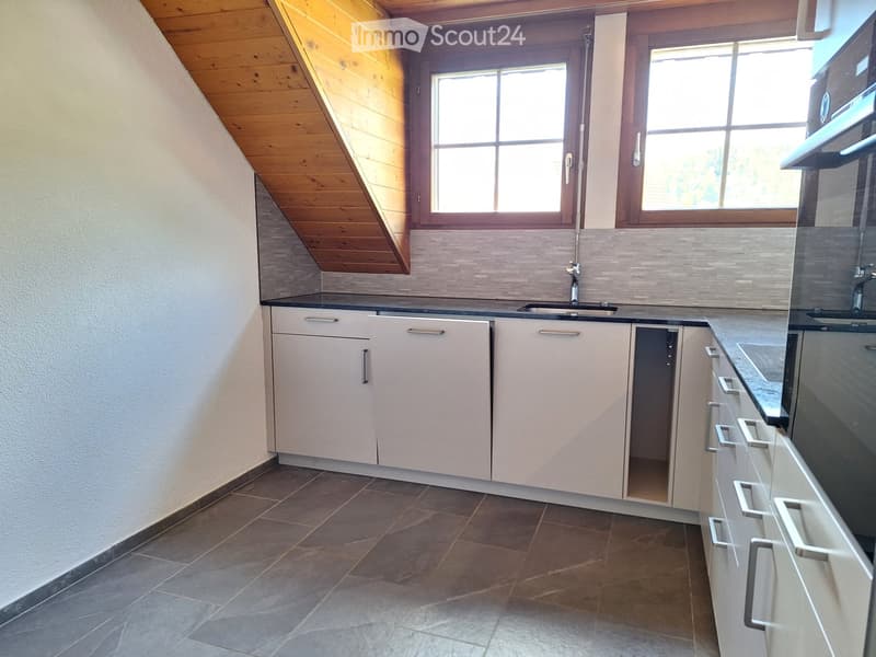 Kitchen with modern white cabinets, granite countertops, double sink with stainless steel faucet, tiled flooring, two large windows