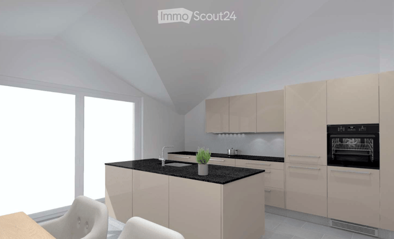Modern kitchen with light-colored cabinets, black countertops, and built-in appliances. Features a central island with a sink and a small potted plant, along with two white stools and a small table.