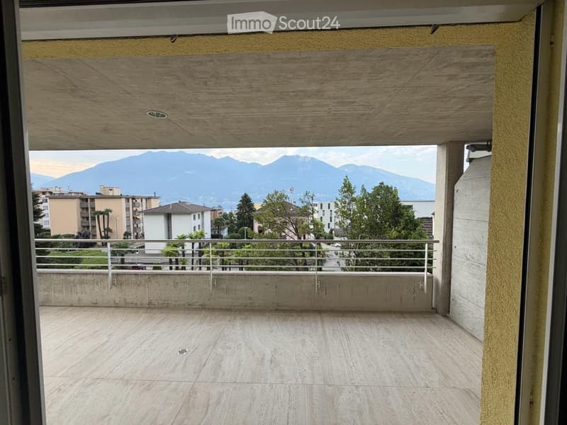 Balcony with wooden ceiling, tiled floor, metal railing, and scenic mountain view.