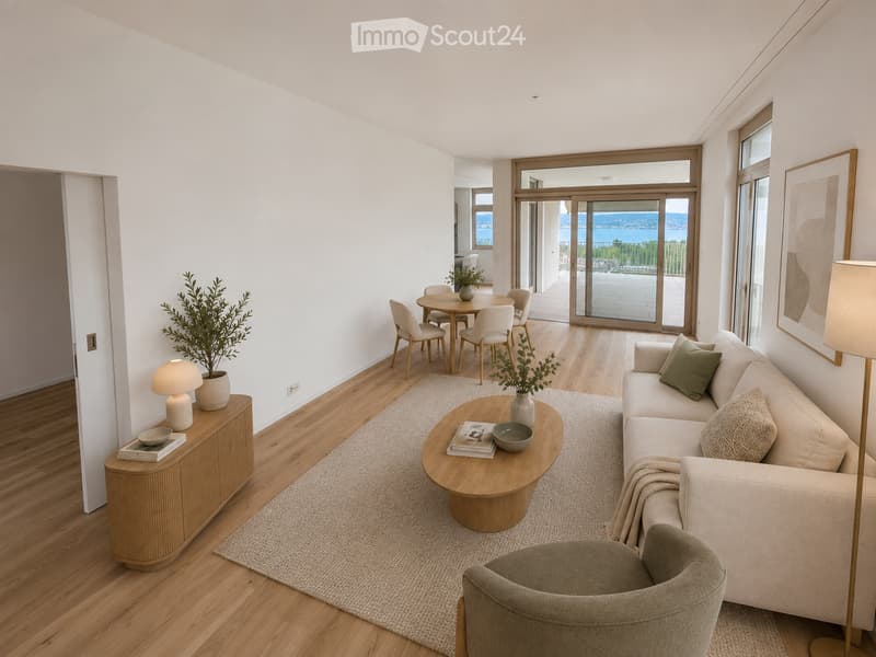 Modern living room with light wood flooring, white walls, and large windows offering a scenic view. Features include a beige sofa, wooden coffee table, side table with lamp, dining area with chairs and table, and decorative plants.