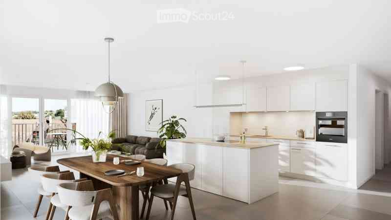 Open-plan living and dining area with a modern kitchen, white cabinets, a wooden dining table with chairs, a sofa, and a pendant light. Large windows and a balcony are visible.