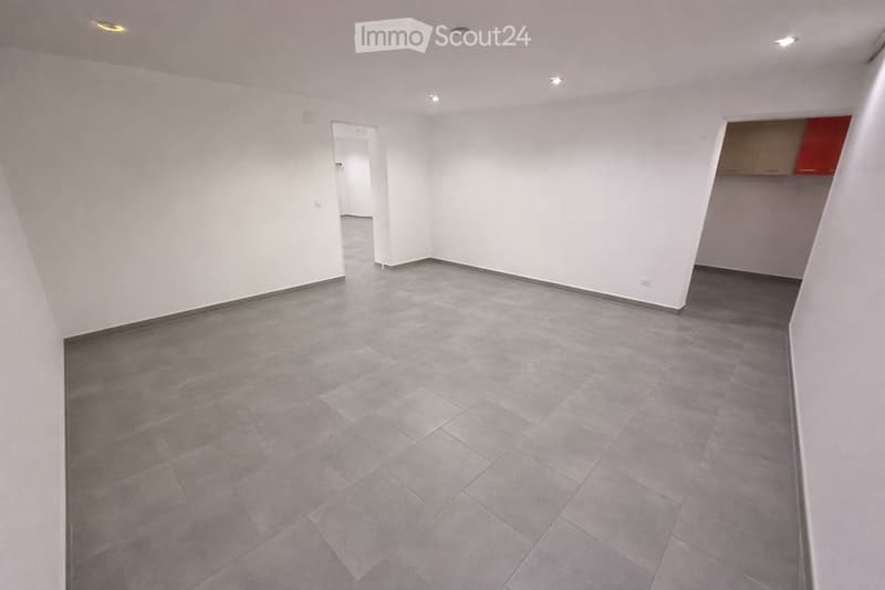 Empty room with white walls and tiled flooring