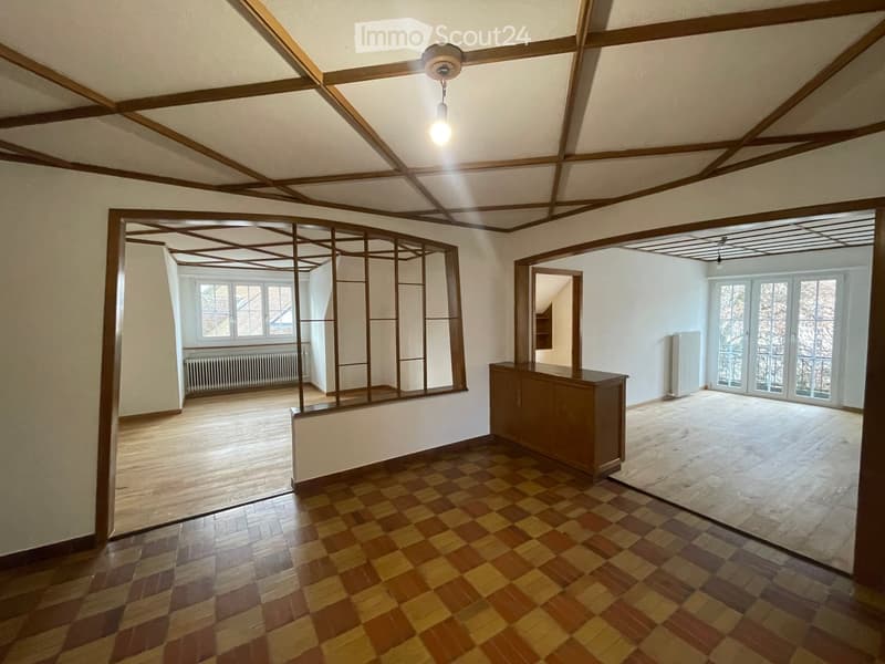 checket floor, wooden ceiling beams, radiator, glass windows, balcony