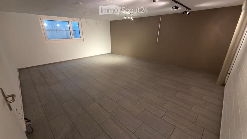 Empty room with tiled floor, white walls, and a single window. No furniture or equipment present.