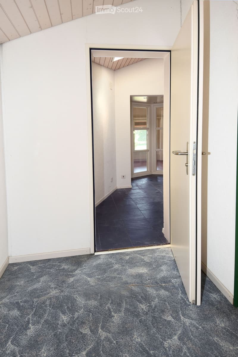 empty room, gray floor, white walls, open door