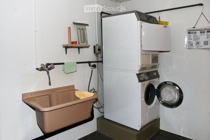 washer and dryer stack, sink, towel, green towel