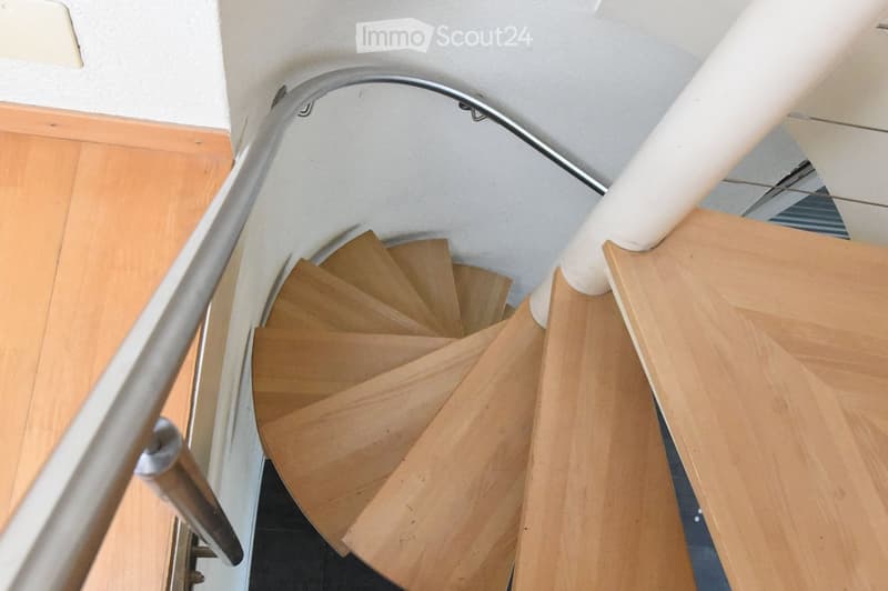 spiral wooden staircase, metallic handrail