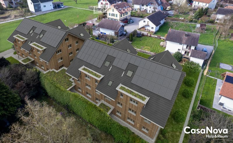 solar panels on roof, wooden exterior, raised ground floor, surrounding houses and greenery
