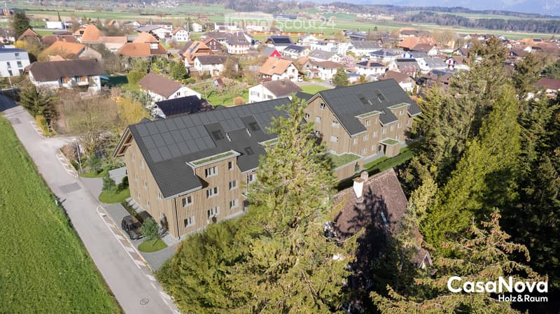 Complex of buildings, modern architecture, solar panels on the roof, surrounded by greenery