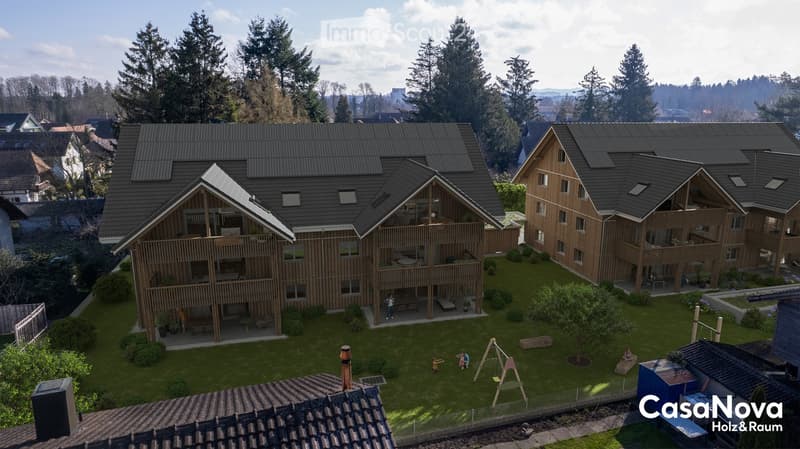 Two story timbered house, flat roof, balcony, green garden, playground, chimney