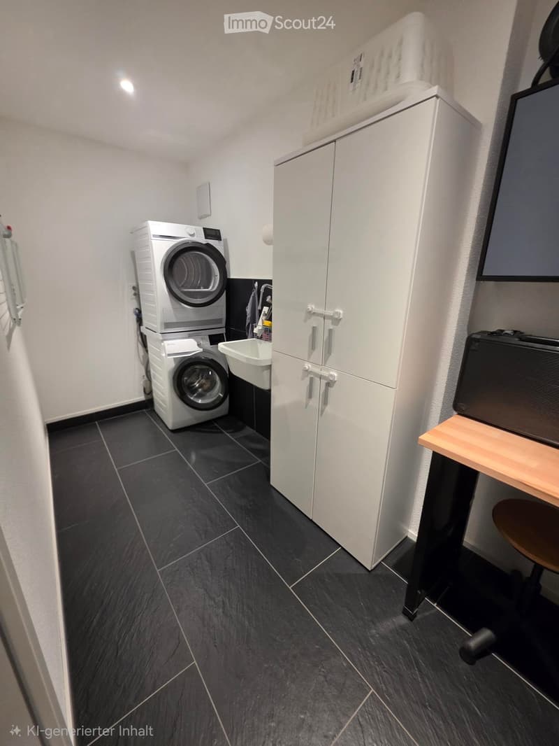 A modern, compact laundry room with dark tiled flooring, white cabinets, a washing machine, dryer, and a small sink.