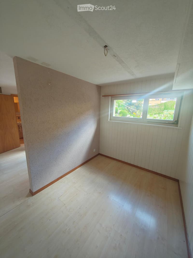 Empty room with wooden flooring, white walls, and a window with white frame. No furniture or equipment present.