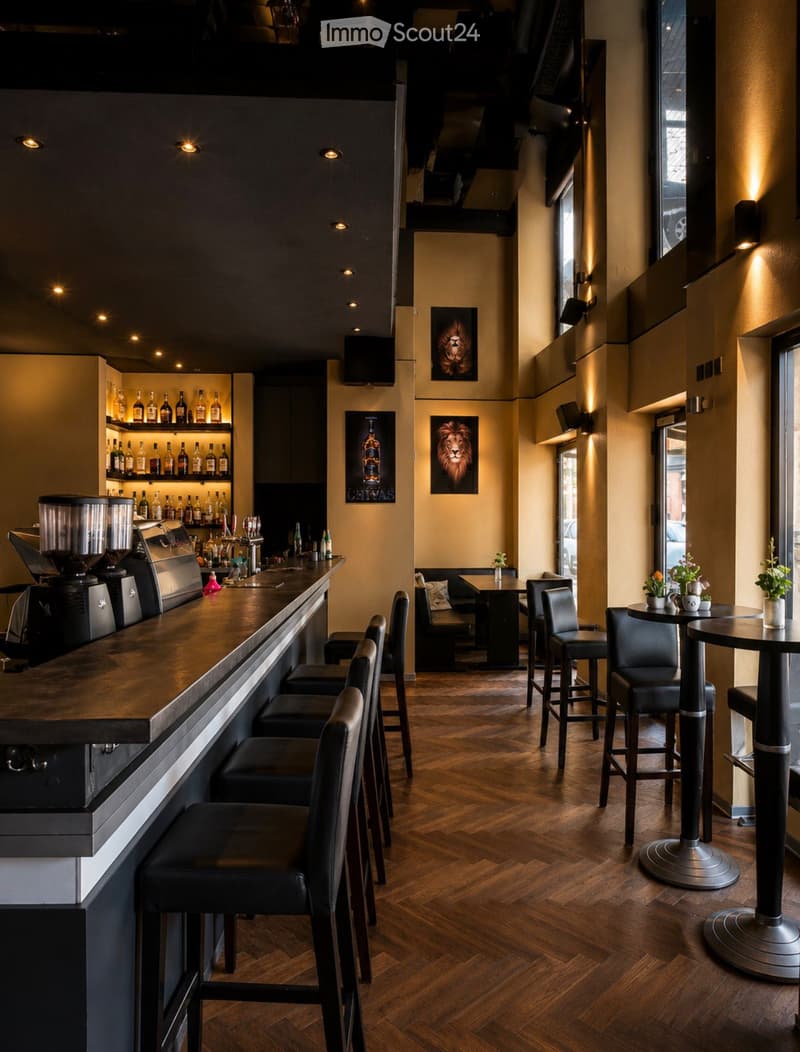 Modern bar area with a long wooden bar counter, several bar stools, a coffee machine, shelves with bottles, and a seating area with tables and chairs.