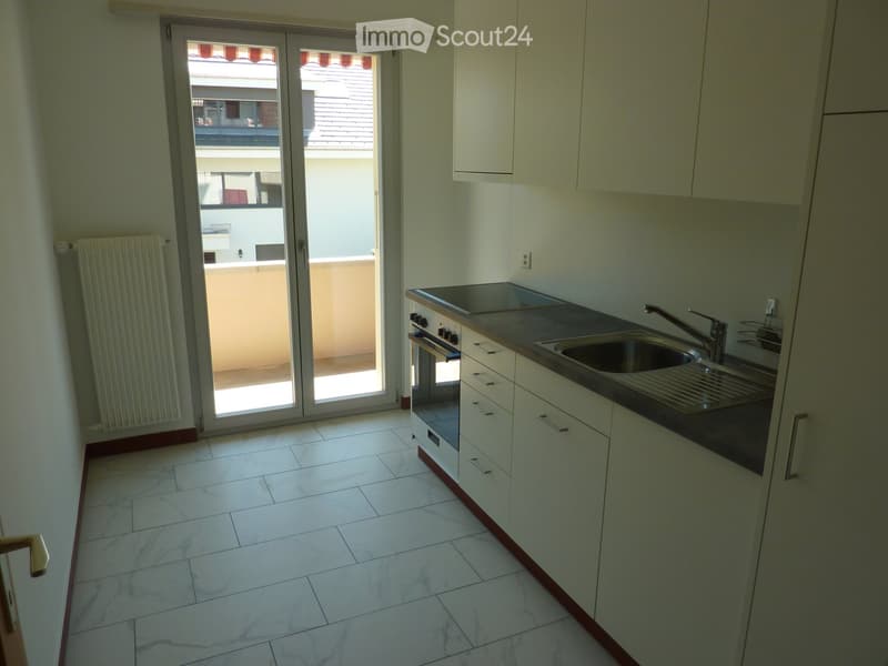 modern kitchen, white tiles, balcony, open door, radiator, sink with faucet, gas stove
