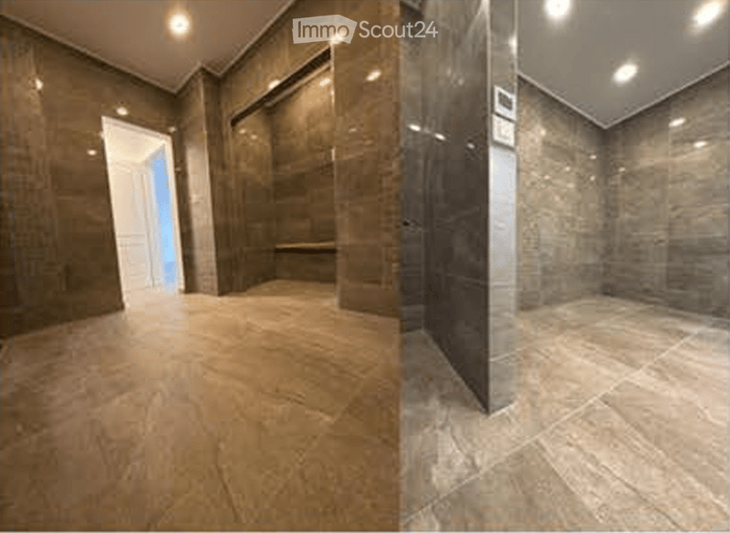 Empty room with polished stone floors and dark brown walls, featuring recessed lighting and a white door leading to another space.