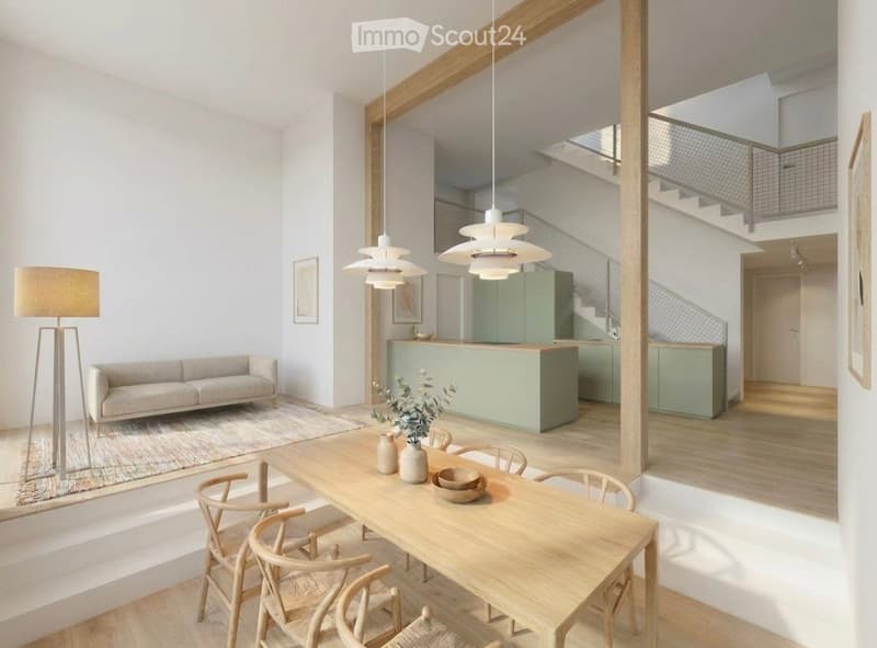 Open-plan living and dining area with light wood flooring, a grey sofa, a wooden dining table with chairs, a kitchen island, pendant lights, and a floor lamp.