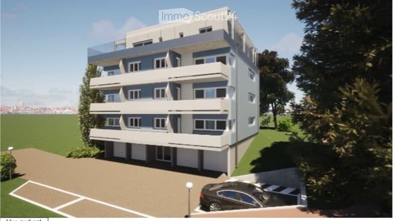 Modern multi-story apartment building with balconies, parking area, and landscaped surroundings.