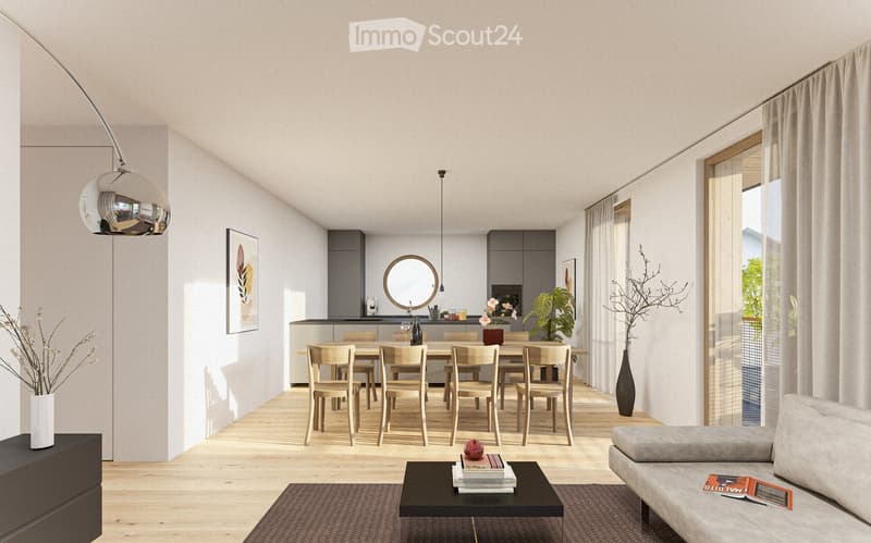 Open-plan living and dining area with wooden flooring, a dining table, and a couch.