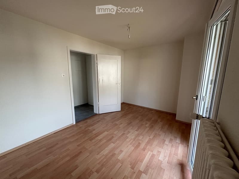 empty room, wooden floor, white walls, two doors, sliding door, radiator, power outlet