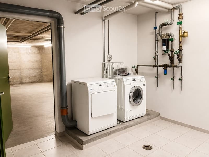 Modern utility room with white washing machine and dryer, visible pipes, and a tiled floor.