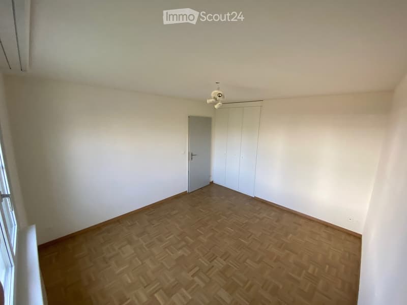 Empty room with wooden flooring, white walls, and a white closet. No furniture or equipment present.