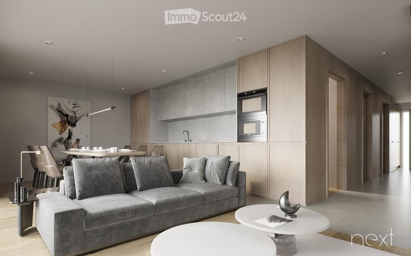 Modern living room and kitchen area with a grey sofa, coffee tables, dining chairs, a microwave, and a sleek kitchen cabinetry.
