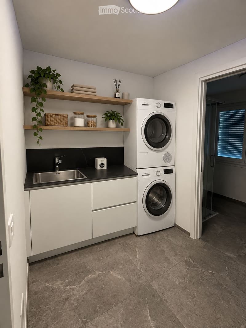 Modern laundry room with white cabinets, a stainless steel sink, a stacked washer/dryer, wooden shelves holding plants and towels, and a small basket.