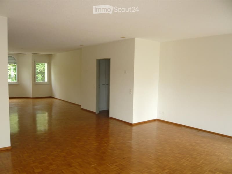 Empty room with wooden flooring, white walls, and two windows. No furniture or equipment present.
