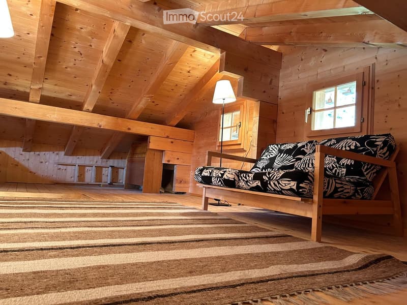 exposed wooden beams, fireplace, rug, lamp, couch