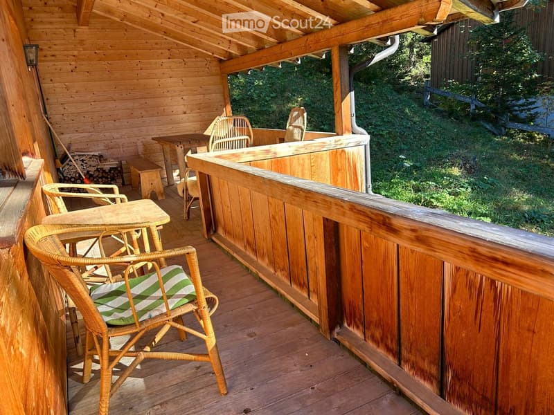 wooden walls, chairs, tables, open terrace, grassy area