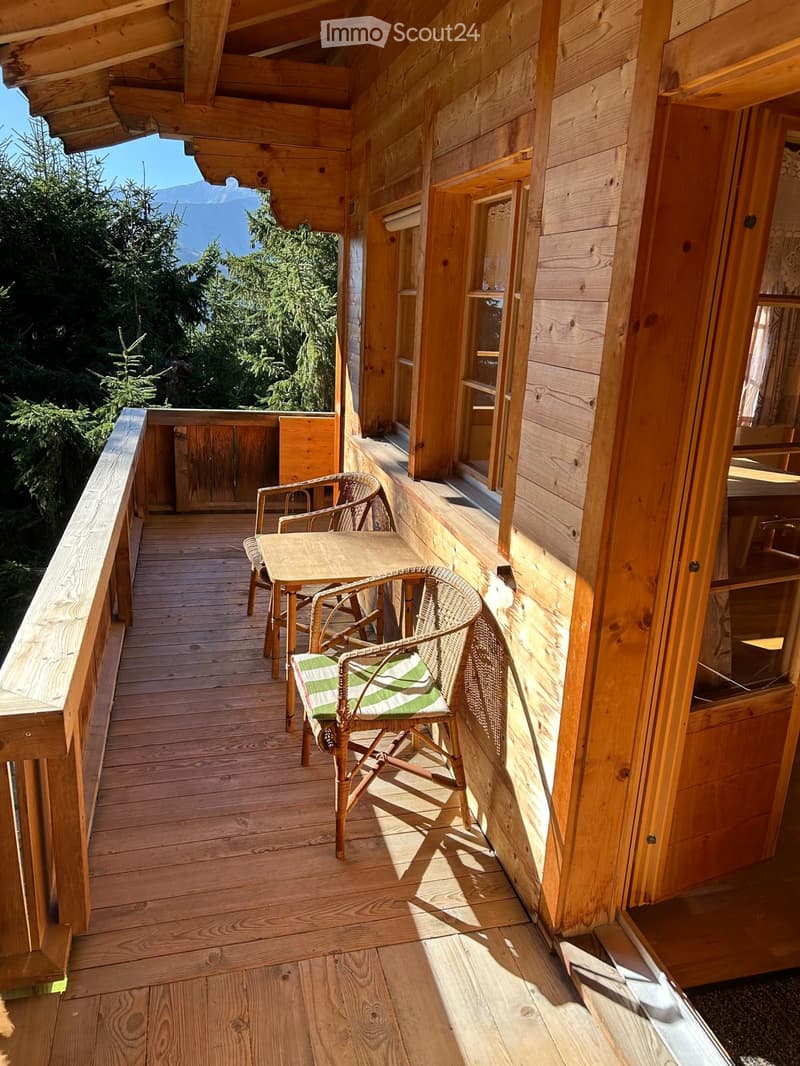 wooden terrace with table and chairs, wooden railing, wooden exterior, mountain view