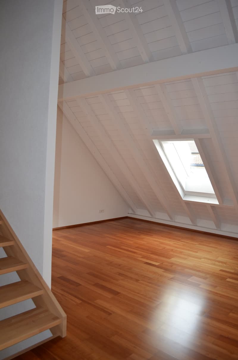 empty attic room, wooden floor, white ceiling, window