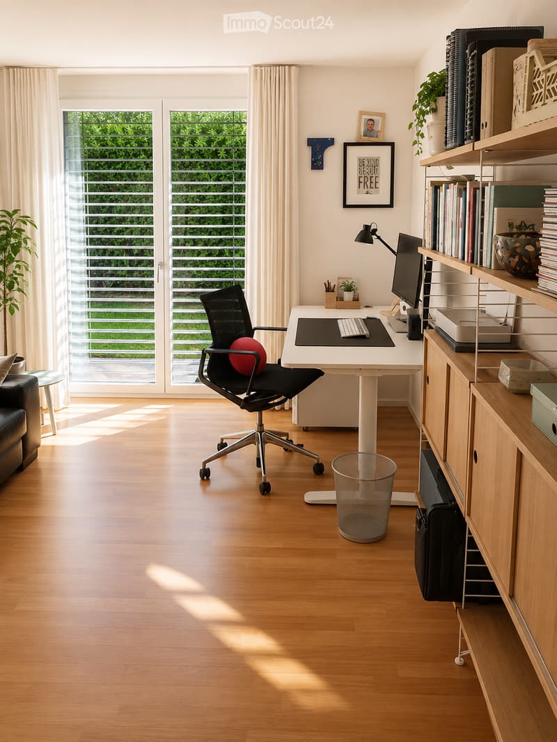 Modern, well-lit office space with a white desk, black office chair, computer monitor, keyboard, bookshelf filled with books, potted plants, and a small sofa near the window.