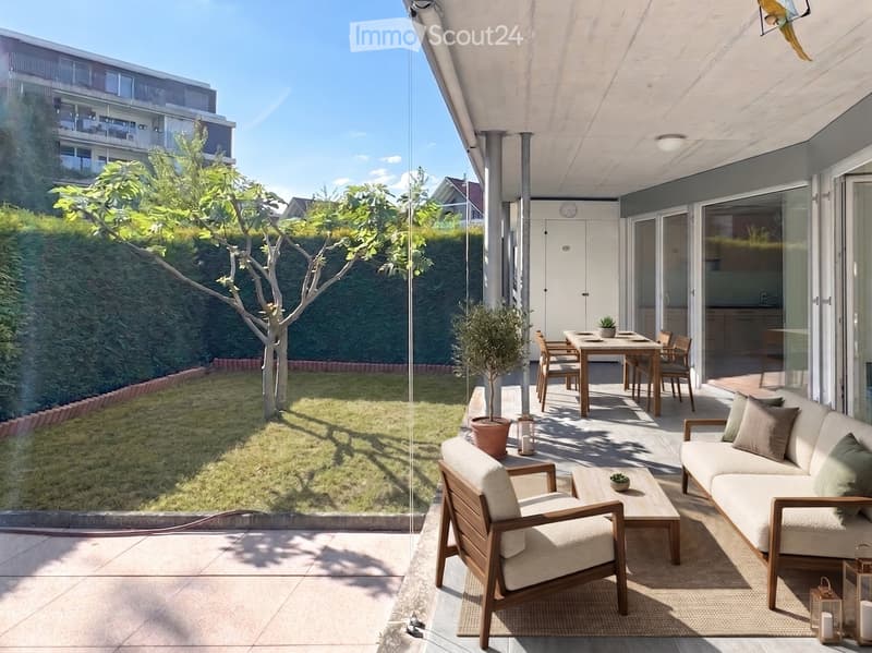 Modern outdoor patio with a sofa, chairs, coffee table, dining table, and potted plants, overlooking a well-maintained garden.