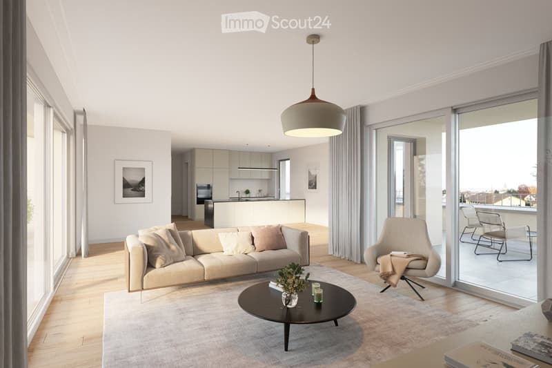 Modern living room with a beige sofa, coffee table, armchair, and a view of the kitchen area. Large windows and sliding glass doors lead to a balcony with outdoor chairs.