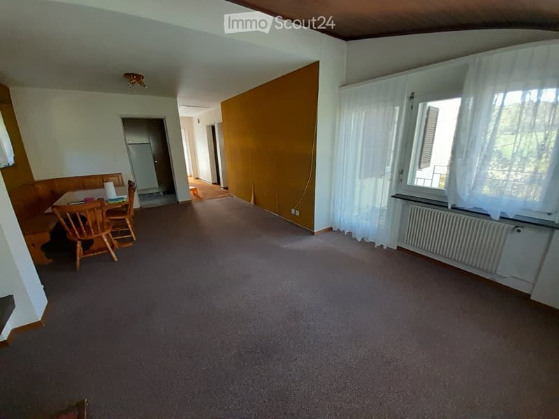 empty room, wooden table, chairs, radiator, carpet, window with curtains, yellow wall