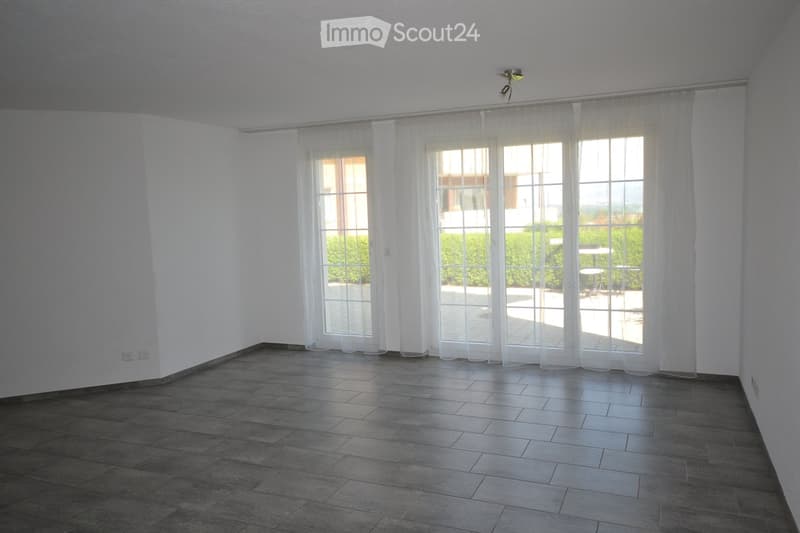 white walls, tile floor, large sliding glass doors, balcony, lamps