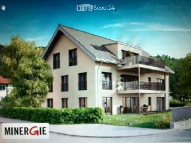 Modern two-story house with white facade, multiple balconies, and a well-maintained garden.
