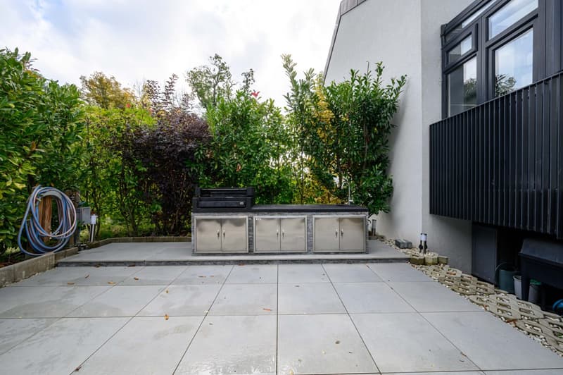 Other. {"visible_features":[],"type":"Garden / Outdoor Area","objects":["outdoor kitchen","grill","outdoor cabinets","outdoor sink","outdoor faucet","outdoor hose","outdoor lighting","outdoor plants","outdoor seating area","outdoor table","outdoor chairs"